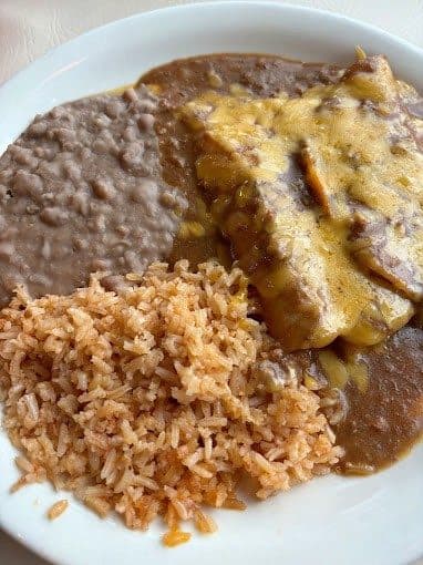 Cheese enchiladas with rice and refried beans